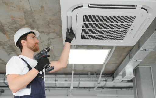 handsome-young-man-electrician-installing-air-cond handsome-young-man-electrician-installing-air-cond